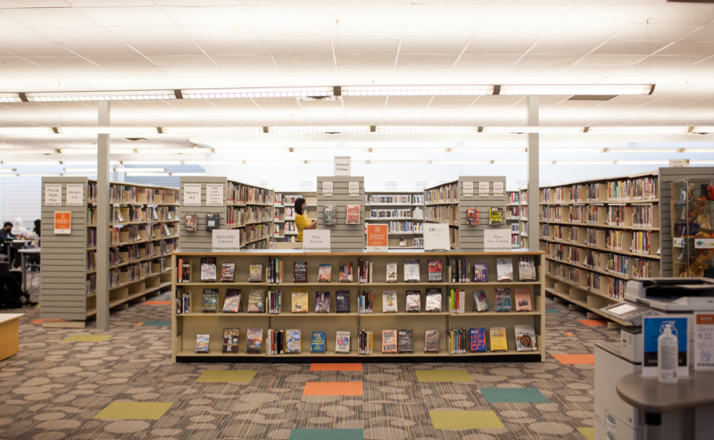 A glimpse of George Mackie Library's interior, showcasing an extensive array of books neatly organized on shelves.