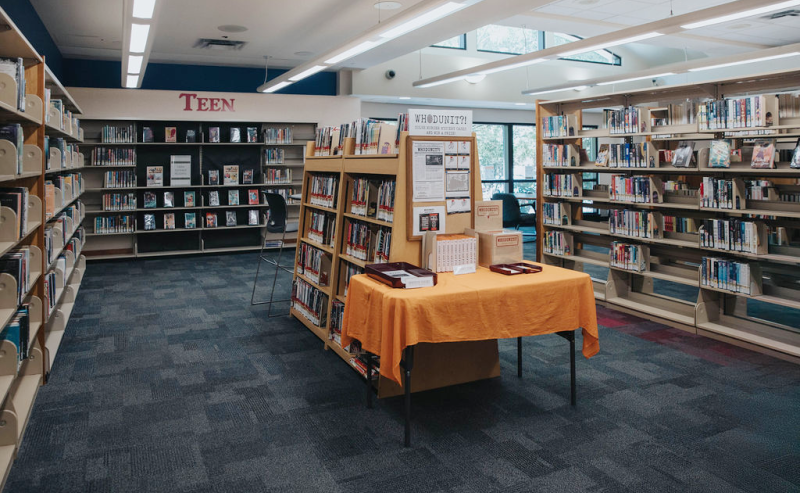 Inside Clearbook Library's Teen area, a vibrant setting with books and a table designed for reading and socializing.