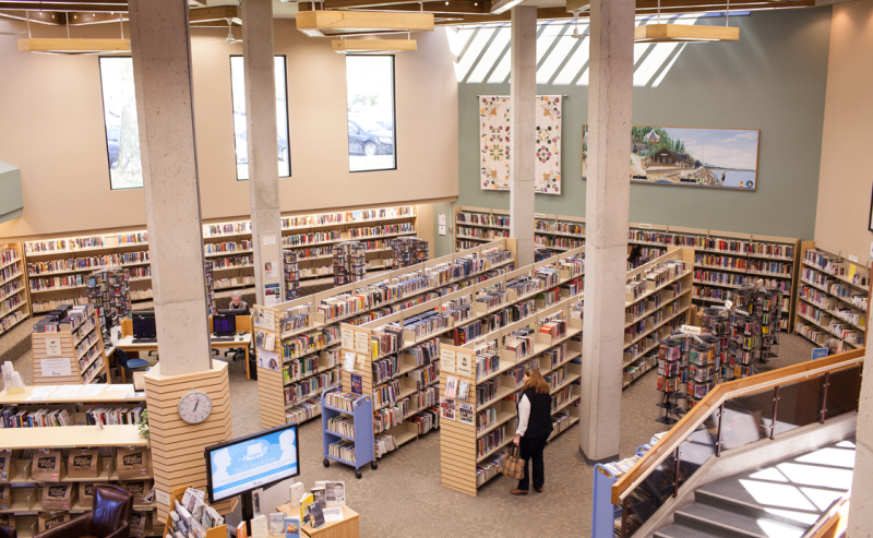 Second-floor perspective of White Rock Library, featuring an extensive collection of books on shelves.