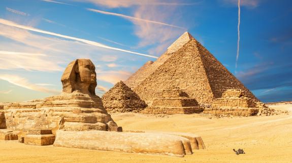 The Sphinx next to the Pyramids in the sands of Giza desert, Egypt.