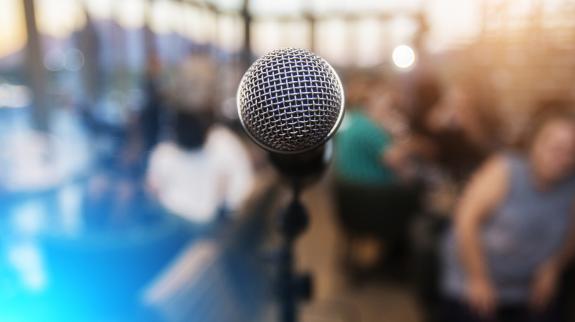 Microphone in front of an out of focus audience