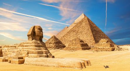 The Sphinx next to the Pyramids in the sands of Giza desert, Egypt.