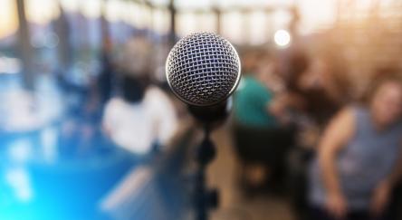 Microphone in front of an out of focus audience