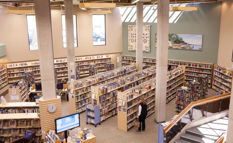  Second-floor perspective of White Rock Library, featuring an extensive collection of books on shelves.