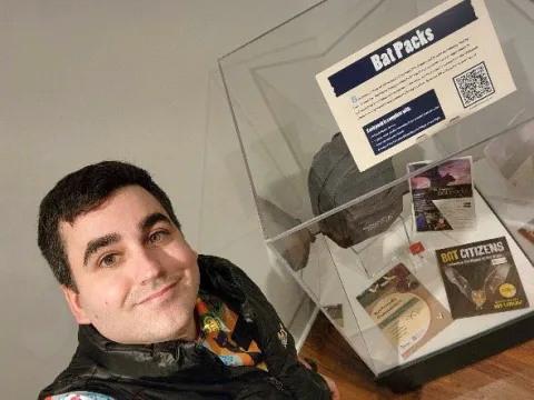 FVRL STEAM Specialist Brandon Monahan poses with the FVRL Bat Pack display at Chilliwack Museum.