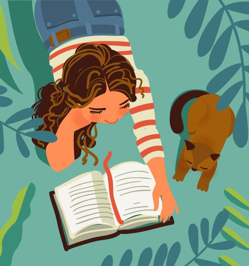 A teenage girl reads a book on the grass. A brown cat stretches next to her. There are leaves all around.